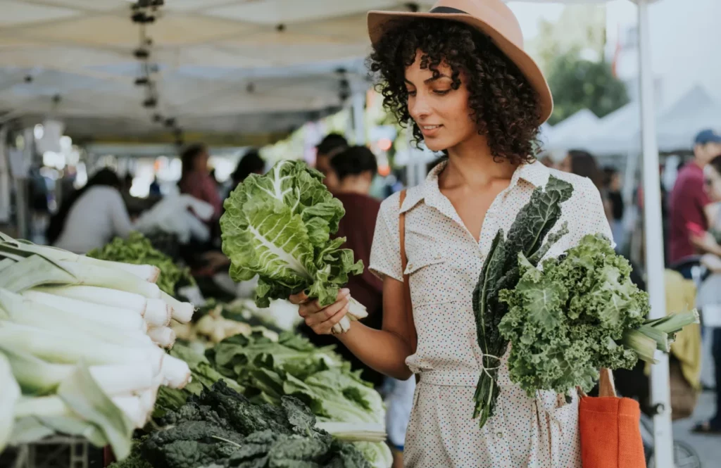 Femme achetant des légumes sur un marché local
